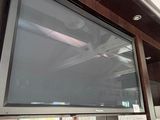 a flat screen tv mounted on the wall in the kitchen
