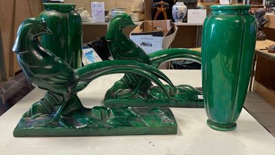 two green vases that are sitting on a table
