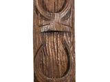 an old wooden door with a carved face on it