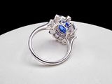 an image of a ring with a blue stone surrounded by diamonds