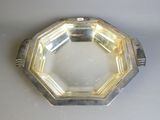 a silver plate on a table with a white background