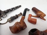 a lot of different types of smoking pipes on the table