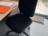 a desk with a chair and a computer on it