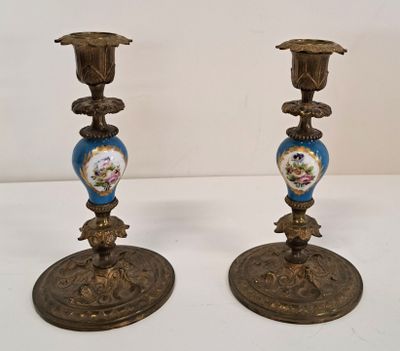 pair of antique brass candlesticks decorated with blue and white flowers
