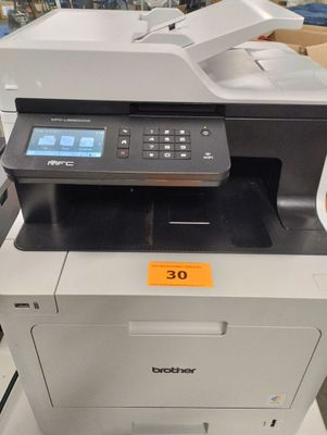 the printer is sitting on top of the table in the store