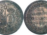 a close up of two silver coins with a crown on them