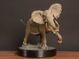 a statue of an elephant that is standing on a table