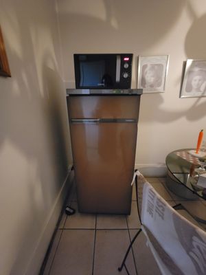 an image of a small kitchen with a microwave and a table