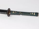 a close up of a sword on a white surface with a white background