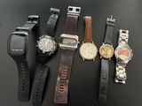 many different types of watches sitting on a table