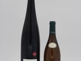 two bottles of wine sitting next to each other on a table