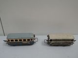 two small toy trains on a white surface