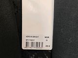 the label on a black tie is attached to a gray suit