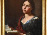 un tableau représentant une femme en train de lire un livre, dans un cadre doré