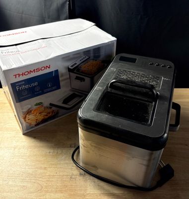 a box of food sitting on a table next to a toaster