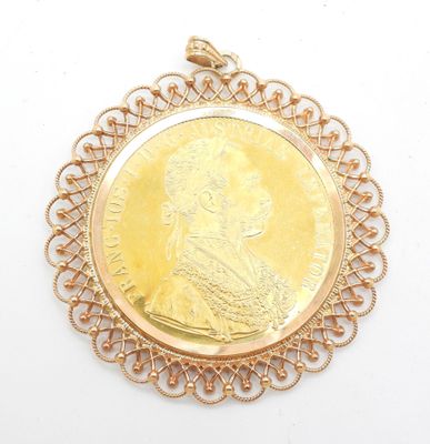 an image of a gold coin pendant with a woman ' s face on it