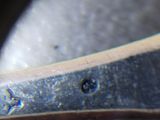 a close up of a pair of scissors on a piece of metal