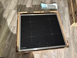 a picture of a stove top with a box on the floor