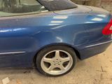 a blue car that is parked in a garage