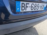 a close up of a blue car with a license plate on it