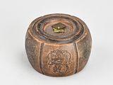 a small wooden box with a clock on top of it