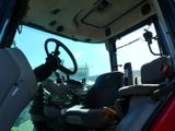 a view of the driver ' s seat and steering wheel of a tractor