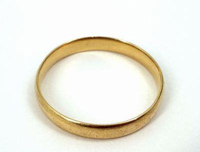 an image of a close up of a gold ring on a white surface