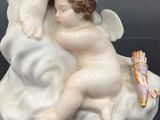 a figurine of an angel holding a baby