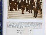 an old photo of a group of men in suits standing on a stage