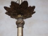 a close up of a lamp post with a bird on it