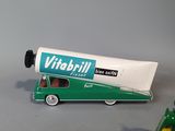 a green toy truck with a tube of toothpaste next to it