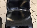 a black chair sitting on a tiled floor in a room