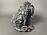 a statue of an elephant that is sitting on a table