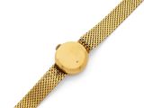 a close up of a gold watch on a white surface