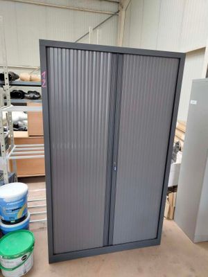 a large metal cabinet in the middle of a warehouse