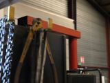 a picture of a room with a bunch of tools hanging from the ceiling