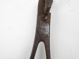 an old pair of pliers sitting on a white surface