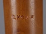 a close up of a wooden object with a name engraved on it