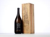 a bottle of wine sitting next to a wooden box