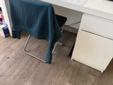 a desk with a chair and a computer on it