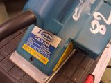 a blue and black vacuum sitting on top of a table