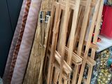 a lot of wooden chairs and brooms on the floor
