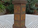 a small wooden lantern on a table outside
