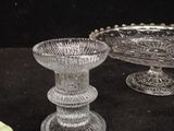 three glass bowls and a plate on a table