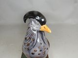 a figurine of a bird with a hat on top of it