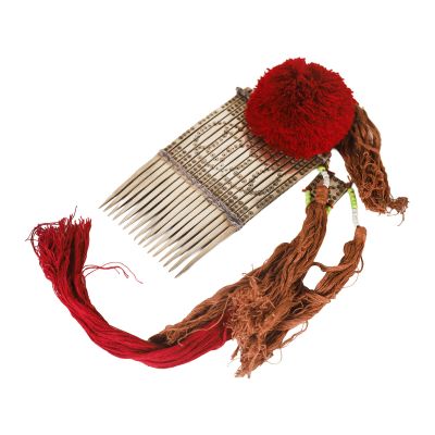 a hair comb with a red pom pom on top of it