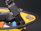 a close up of a yellow helmet with a black strap