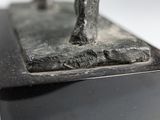 a statue of a man on a horse on a black base