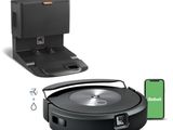 an image of a robotic vacuum cleaner with a phone and a charger