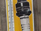 a sticker of a spark spark on the side of a wooden fence